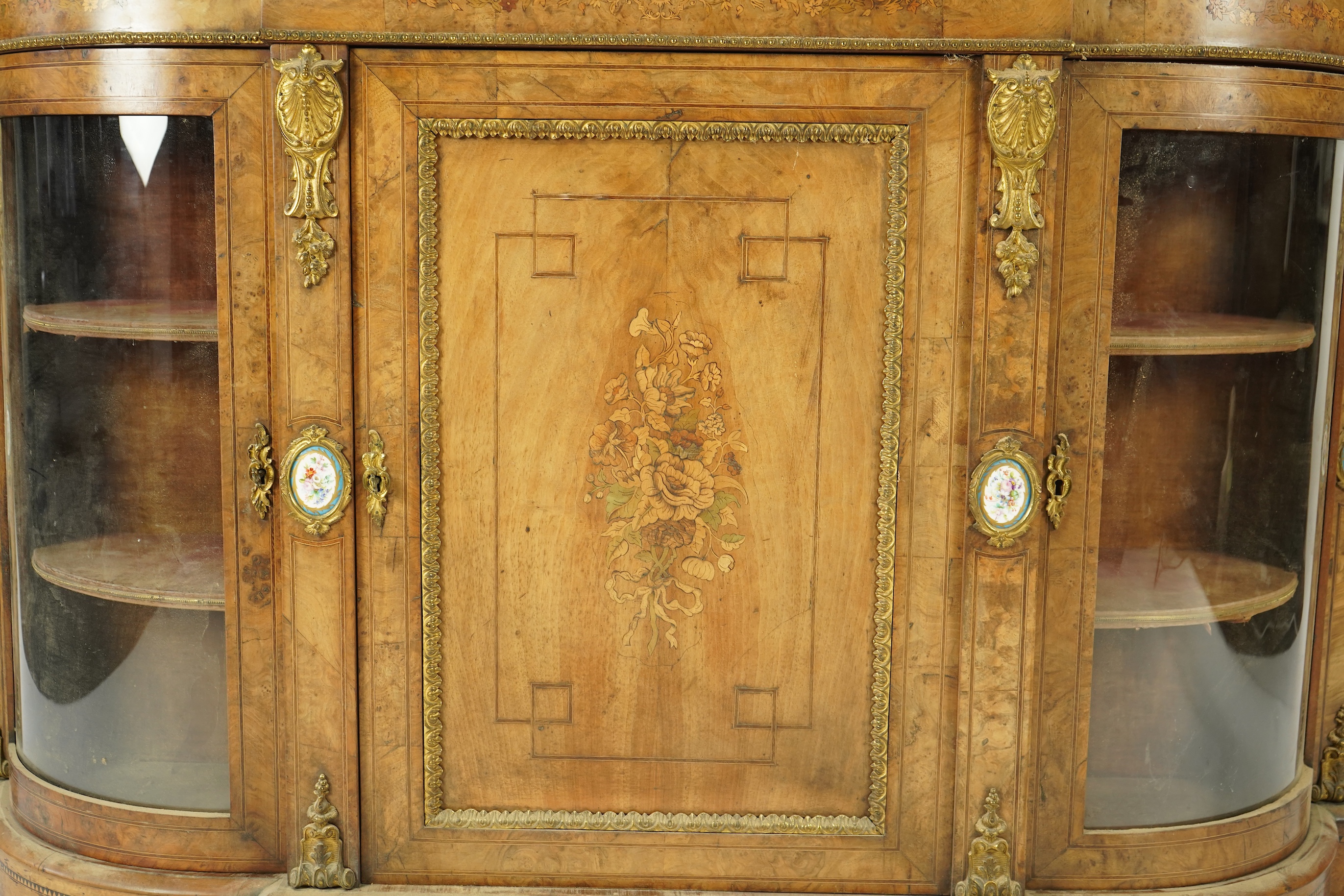 A Victorian marquetry inlaid, gilt metal mounted bowfront side cabinet